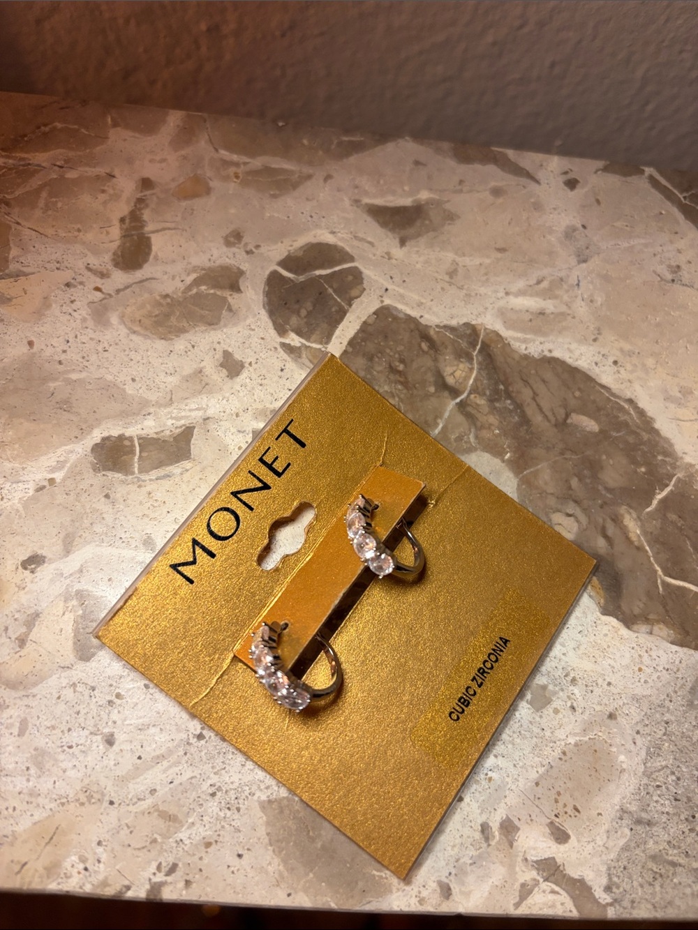 Silver-tone Monet half hoop earrings with cubic zirconia.